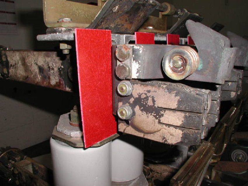 A Close-up Of A Red And White Breaker Box